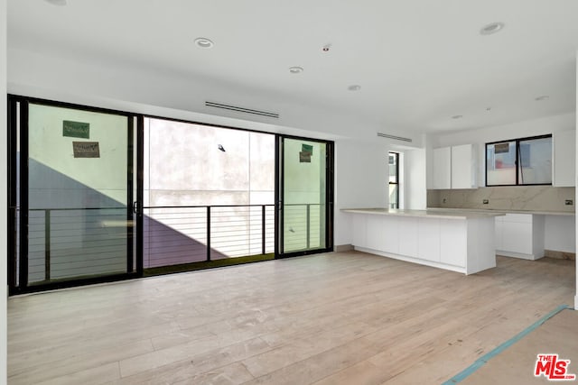 unfurnished living room featuring light wood-type flooring