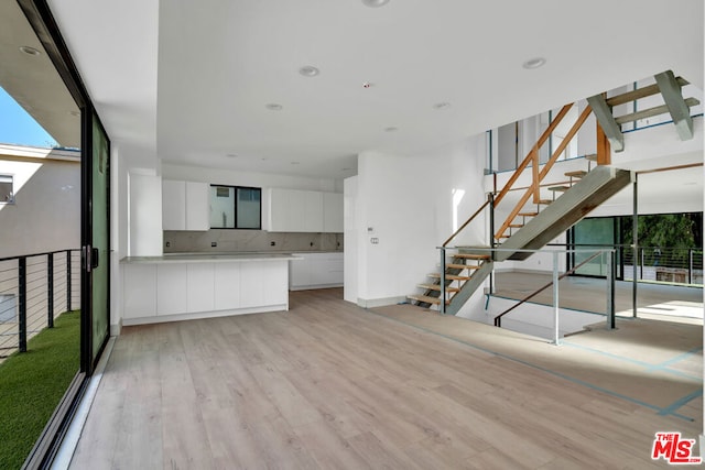 unfurnished living room with light wood-type flooring