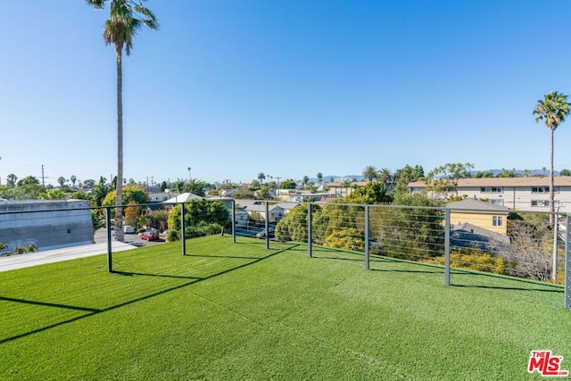 view of property's community featuring a lawn