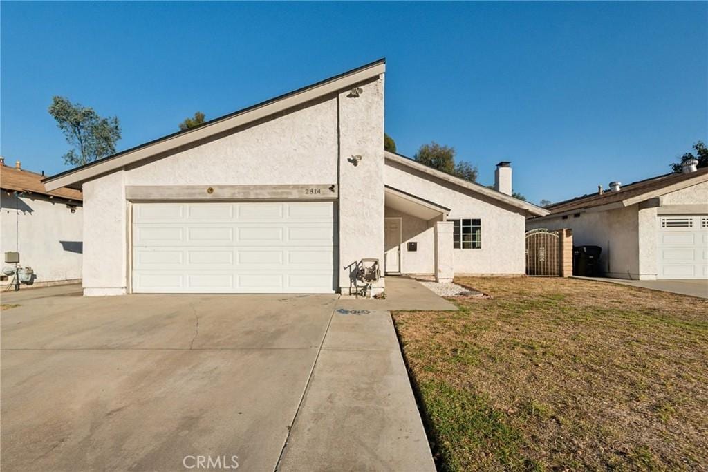 view of front of property with a front yard and a garage