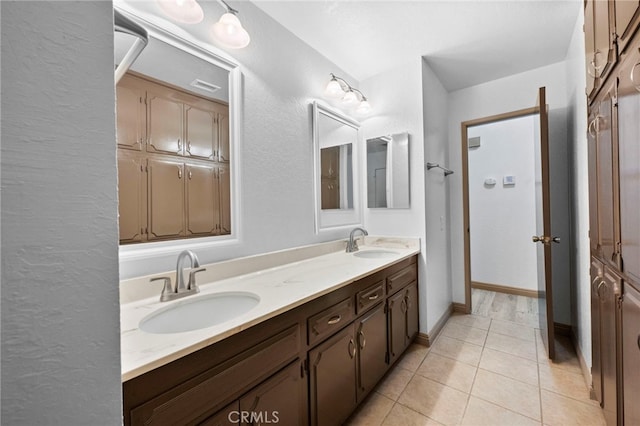 bathroom featuring tile patterned flooring and vanity