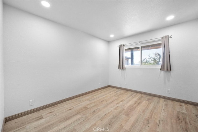 unfurnished room featuring light hardwood / wood-style flooring