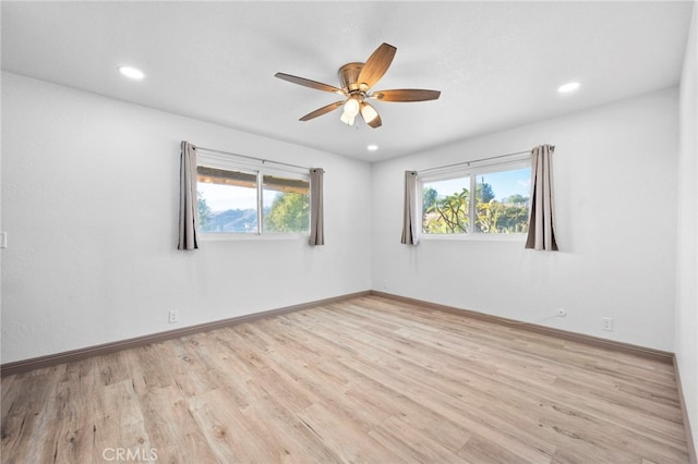 unfurnished room with ceiling fan and light hardwood / wood-style flooring