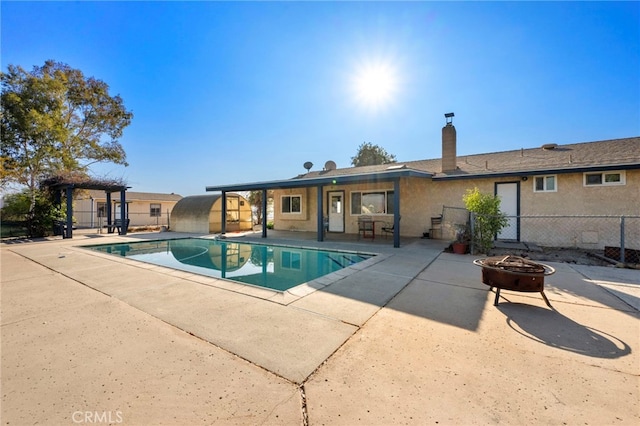 view of swimming pool featuring a patio area and an outdoor fire pit