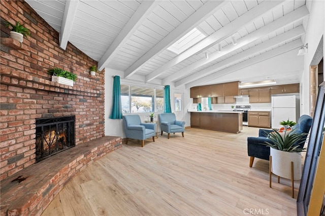 living room featuring a brick fireplace, vaulted ceiling with beams, and light hardwood / wood-style flooring