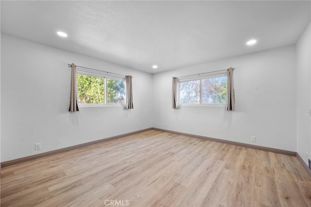 unfurnished room featuring light wood-type flooring