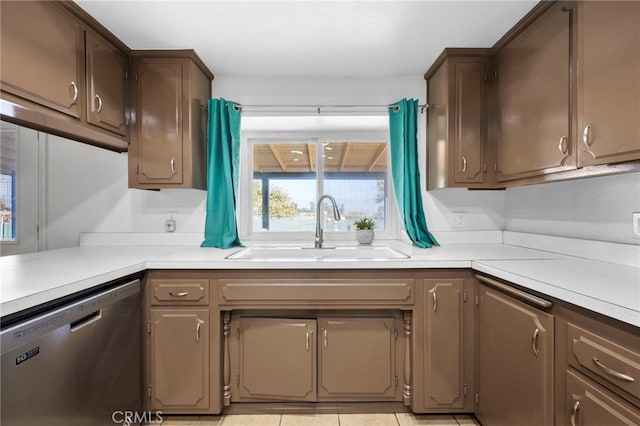 kitchen featuring dishwasher, light tile patterned floors, and sink