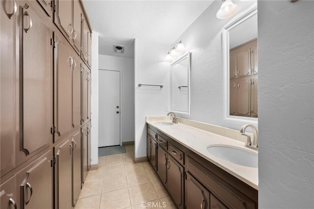 bathroom with tile patterned flooring and vanity