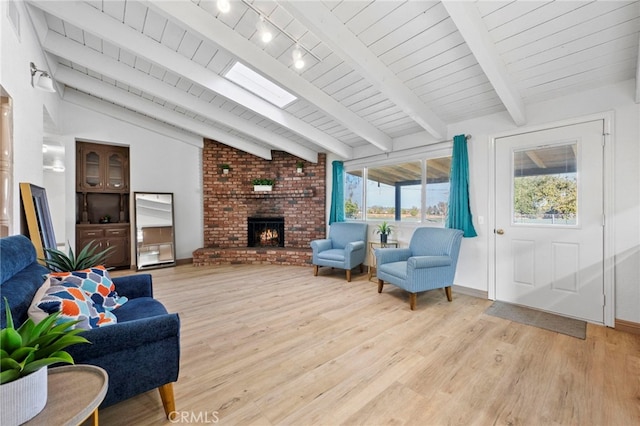 living room with lofted ceiling with beams, light wood-type flooring, a fireplace, and wooden ceiling