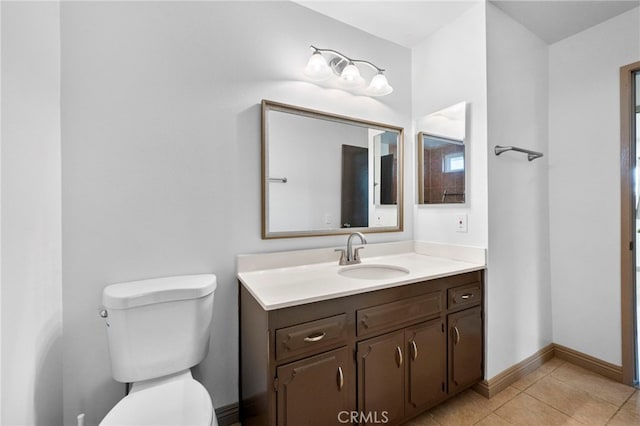 bathroom featuring tile patterned flooring, vanity, and toilet