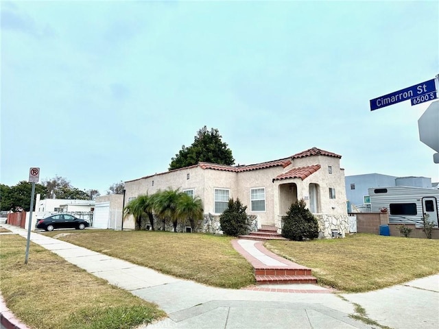 mediterranean / spanish-style house with a front lawn