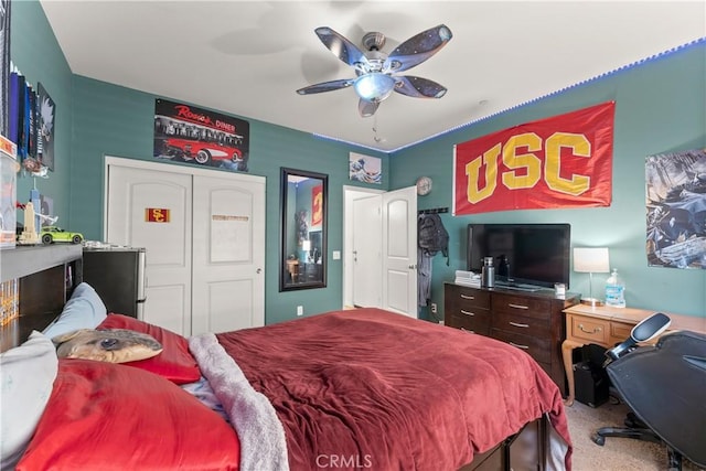 carpeted bedroom with ceiling fan and a closet