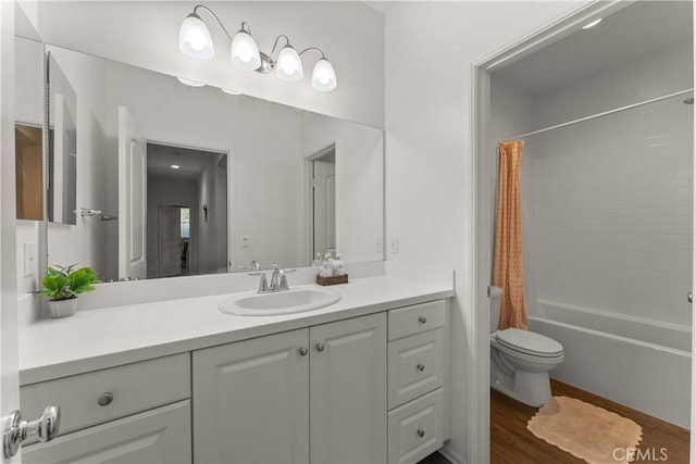 full bathroom featuring hardwood / wood-style flooring, vanity, toilet, and shower / bath combo with shower curtain