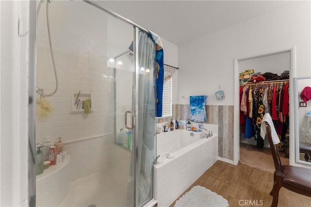 bathroom featuring plus walk in shower and hardwood / wood-style floors