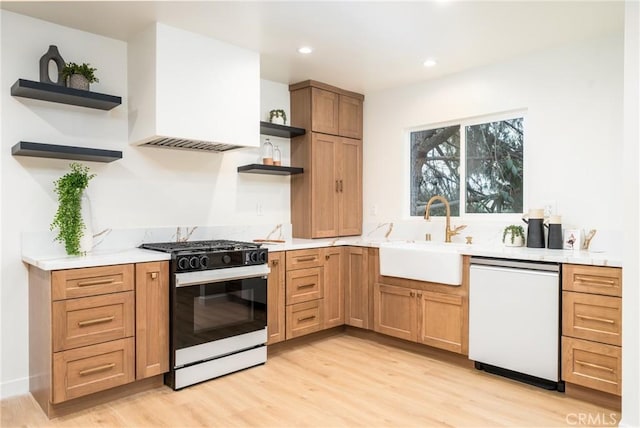 kitchen featuring white appliances, light hardwood / wood-style floors, custom exhaust hood, and sink