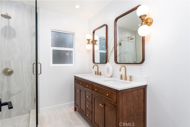 bathroom with vanity and a shower with shower door