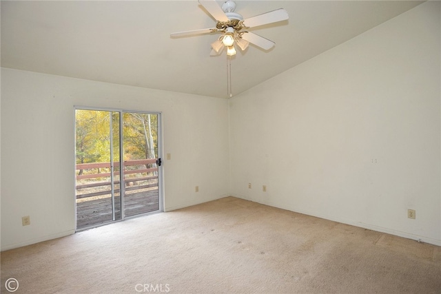 empty room featuring ceiling fan, light colored carpet, and vaulted ceiling