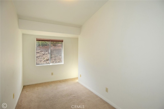 unfurnished room featuring light colored carpet