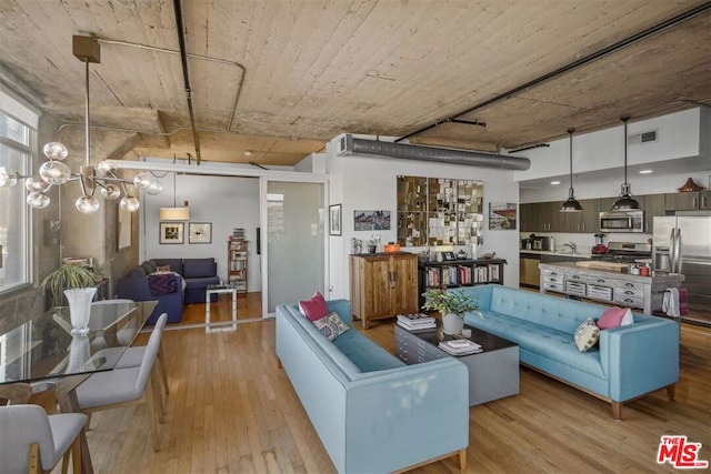 living room with sink and light hardwood / wood-style flooring