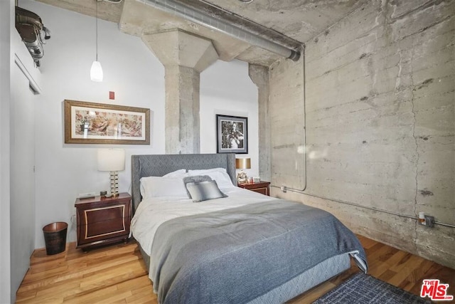 bedroom with wood-type flooring