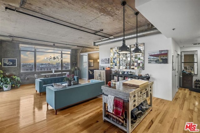 interior space with an inviting chandelier, light hardwood / wood-style flooring, and hanging light fixtures