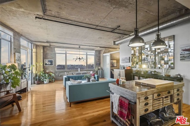 kitchen featuring decorative light fixtures and hardwood / wood-style flooring