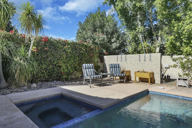 view of pool featuring a patio area and an in ground hot tub