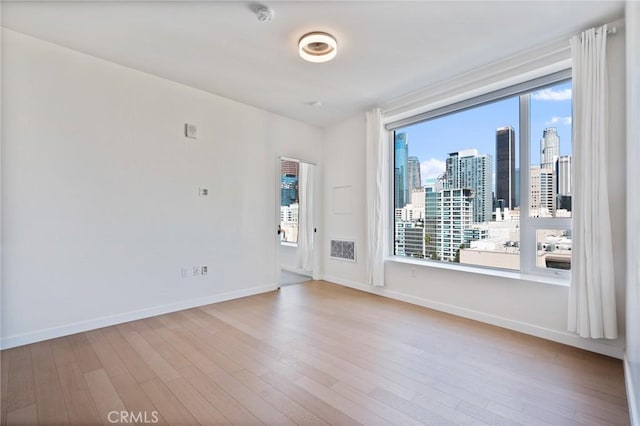 empty room with light hardwood / wood-style flooring