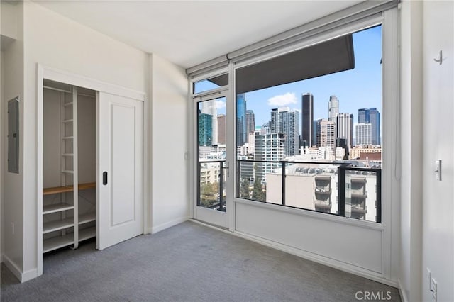 bedroom featuring dark colored carpet, electric panel, and a closet