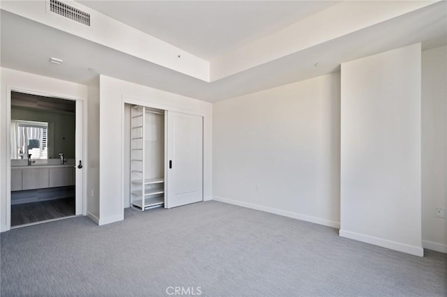 unfurnished bedroom featuring carpet flooring and a closet