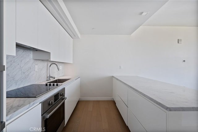 kitchen with white cabinetry, sink, dark wood-type flooring, oven, and black electric stovetop