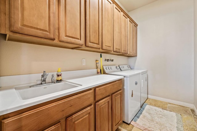 laundry area featuring sink, cabinets, and washing machine and dryer