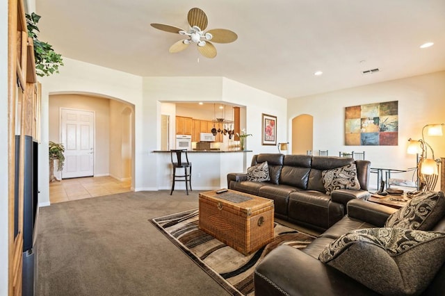 living room with ceiling fan and light carpet