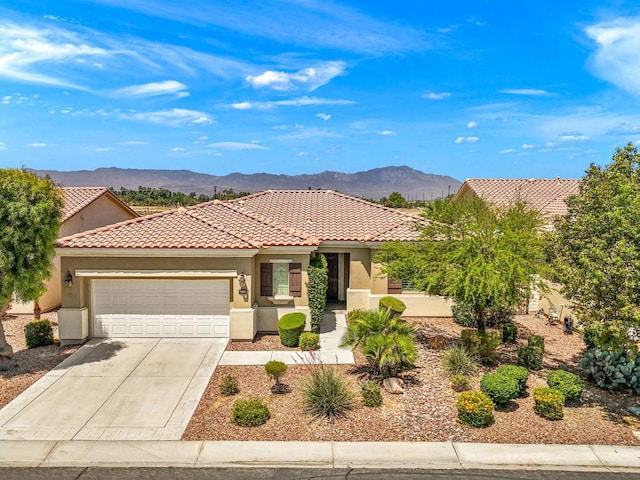 view of front of home with a mountain view and a garage