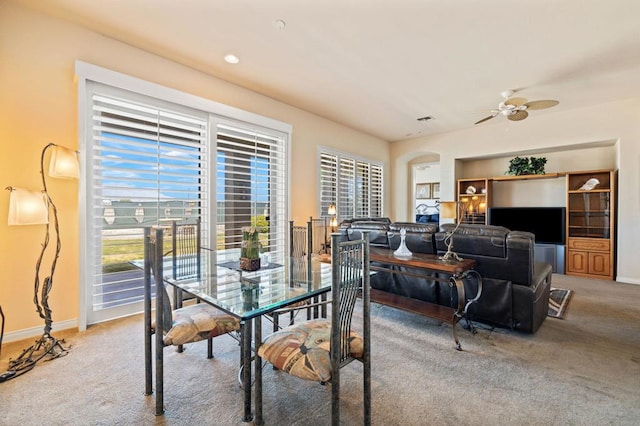 dining space featuring ceiling fan and carpet