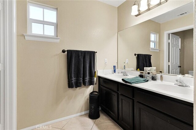 bathroom with tile patterned floors, vanity, and toilet