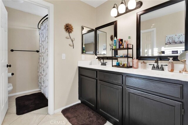 bathroom featuring toilet, vanity, and tile patterned floors