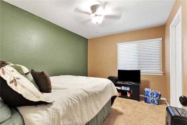 carpeted bedroom with ceiling fan