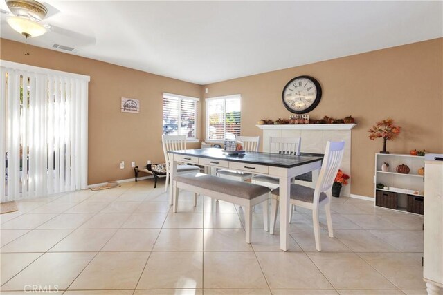 dining area featuring ceiling fan and light tile patterned flooring