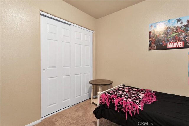 bedroom with carpet flooring and a closet