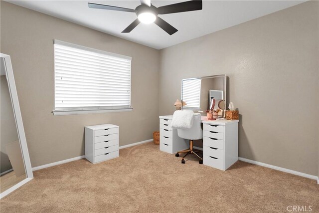 office space with ceiling fan, light carpet, and a wealth of natural light