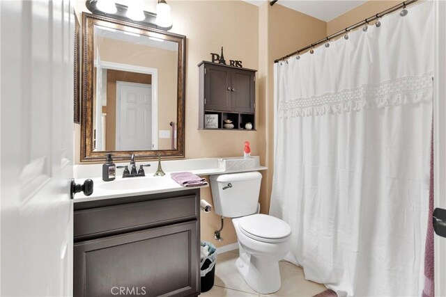 bathroom featuring tile patterned flooring, vanity, a shower with shower curtain, and toilet