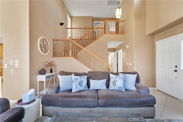 tiled living room featuring a high ceiling