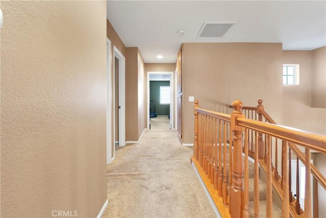 hallway with light carpet