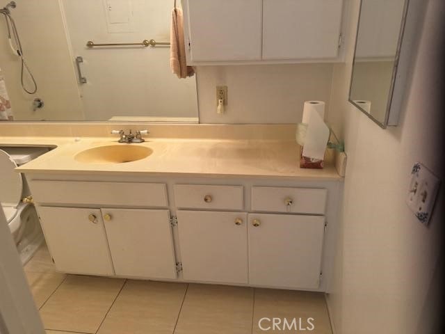 bathroom with tile patterned floors and vanity