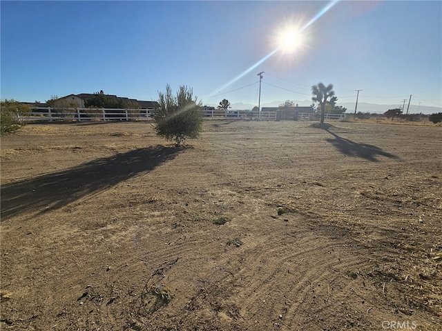 view of yard with a rural view