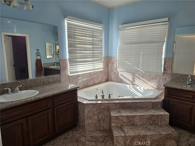 bathroom with tiled bath and vanity