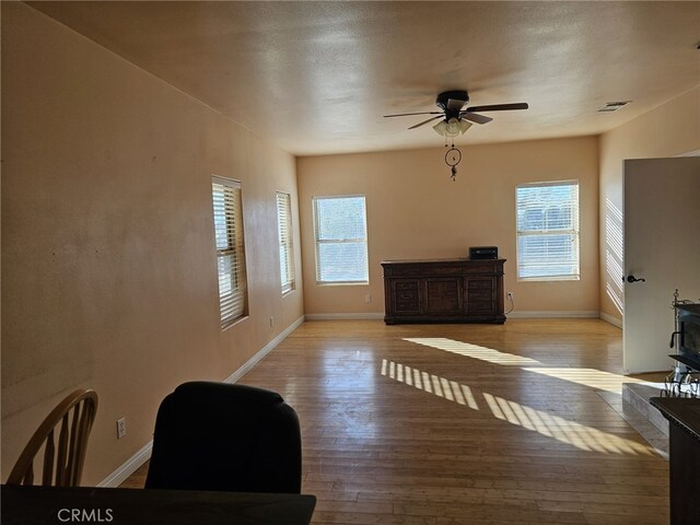 unfurnished living room with light hardwood / wood-style floors and ceiling fan