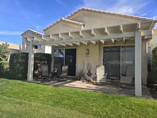 back of property featuring a yard, a pergola, and a patio