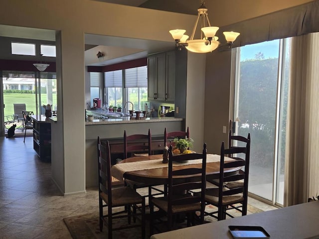 dining area featuring plenty of natural light and a notable chandelier